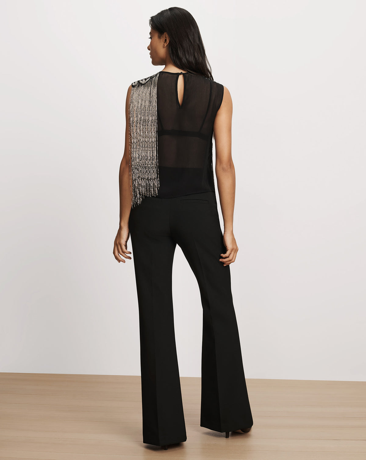 Veronica Beard Black sleeveless top with crystal fringe and trousers.