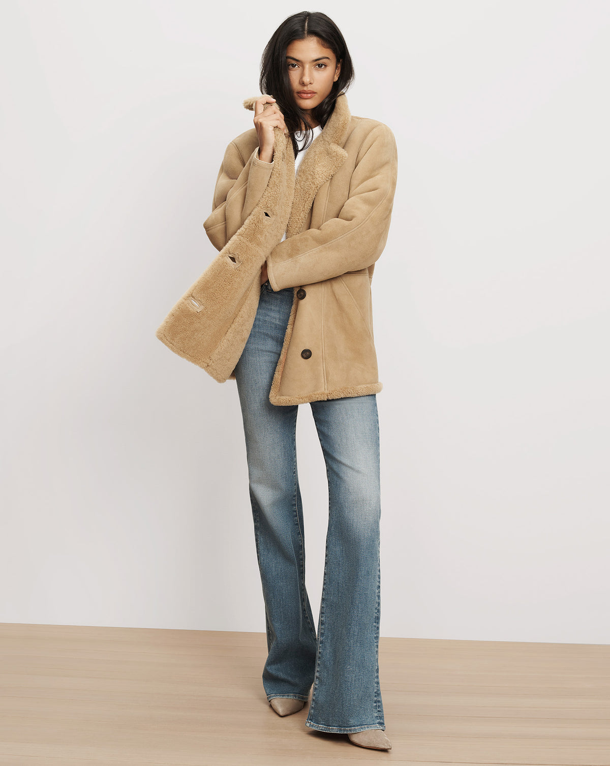 Veronica Beard Tan shearling jacket and blue flare jeans.