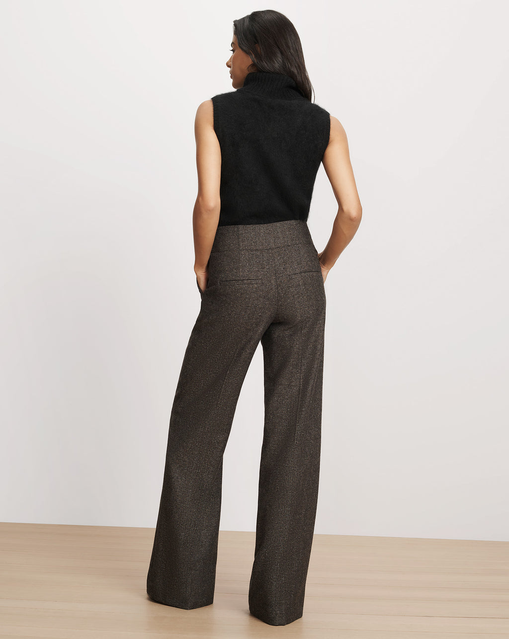 Veronica Beard Brown wide-leg tweed trousers and black sweater.