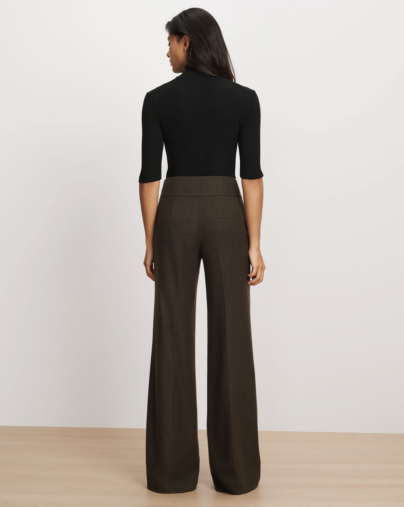 Veronica Beard Black turtleneck top and brown wide-leg pants.