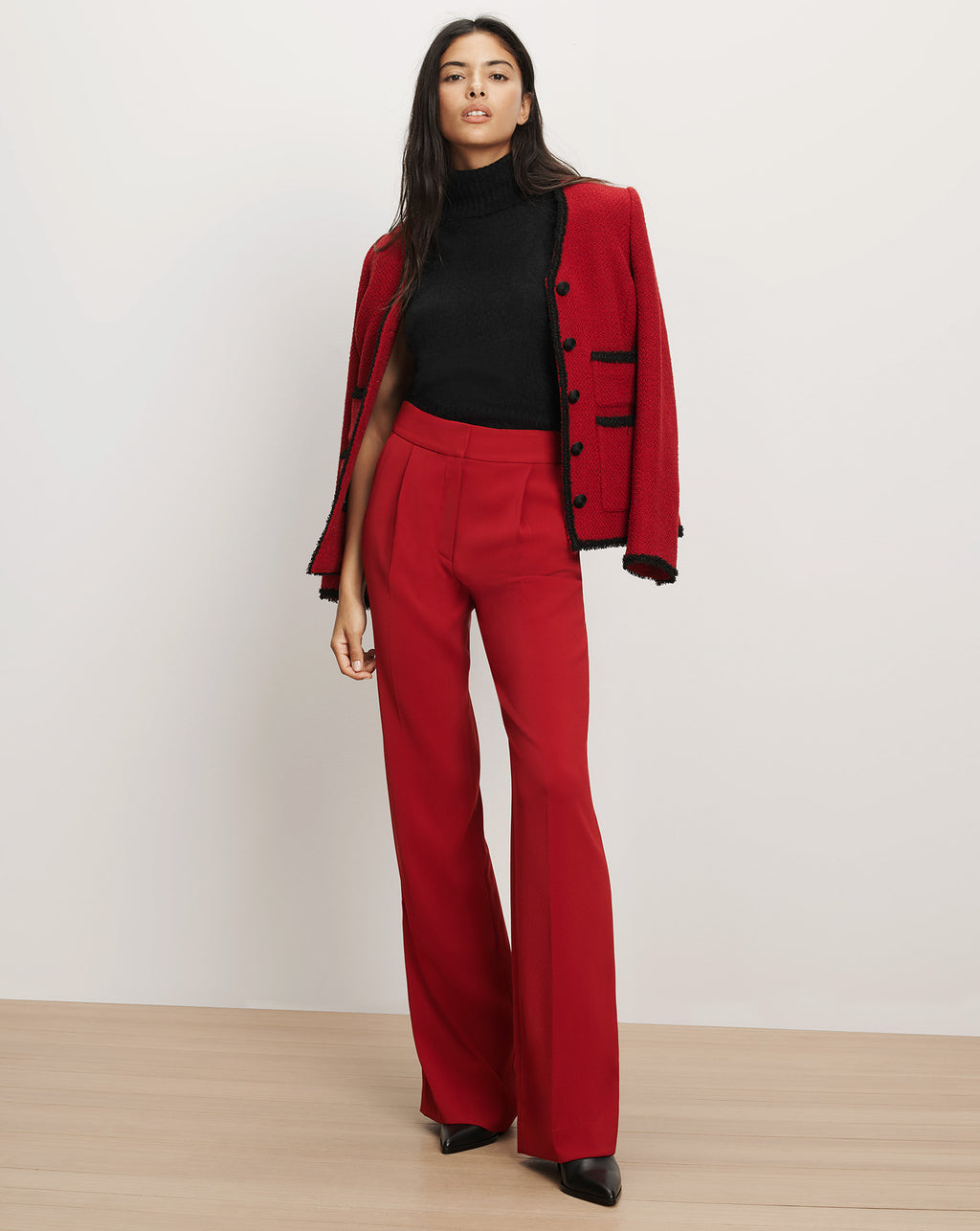 Veronica Beard Red tweed jacket, black turtleneck, red trousers.