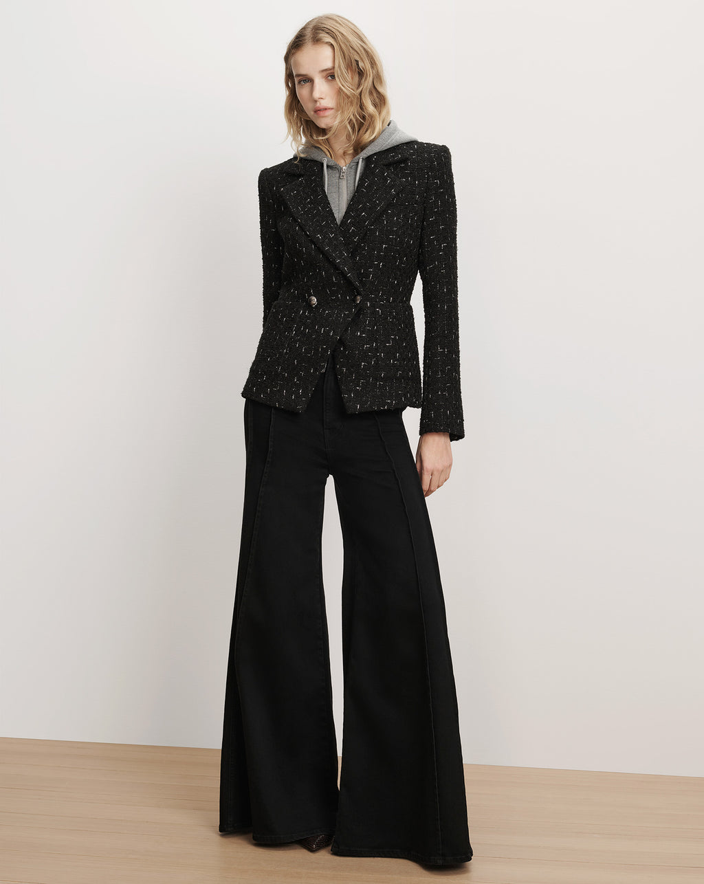 Veronica Beard Black tweed blazer and flared denim jeans.