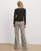 Veronica Beard Dark green embellished sweater and grey jeans.