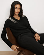 Veronica Beard Black v-neck sweater with embellished shoulders.