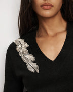 Veronica Beard Black v-neck sweater with silver beaded leaf.