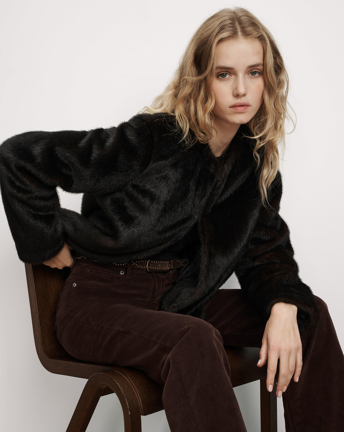 Veronica Beard Black faux fur jacket and brown corduroy pants.