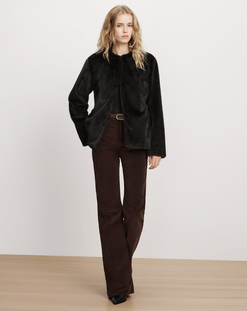 Veronica Beard Black faux fur collarless jacket, brown corduroy pants.