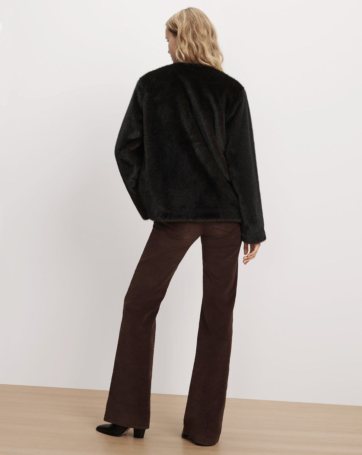 Veronica Beard Black faux fur jacket and brown trousers.