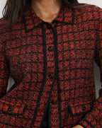Veronica Beard Red tweed button-down jacket with black trim.