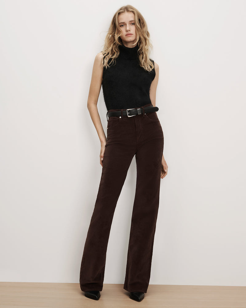 Veronica Beard Black sleeveless turtleneck and brown corduroy pants.