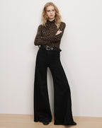Veronica Beard Brown zebra turtleneck and black wide-leg jeans.