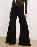 Veronica Beard Black high-waisted wide-leg denim pants.