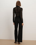 Veronica Beard Black lace collared shirt and black trousers.