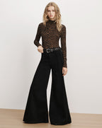 Veronica Beard Brown zebra print turtleneck and black flared jeans.