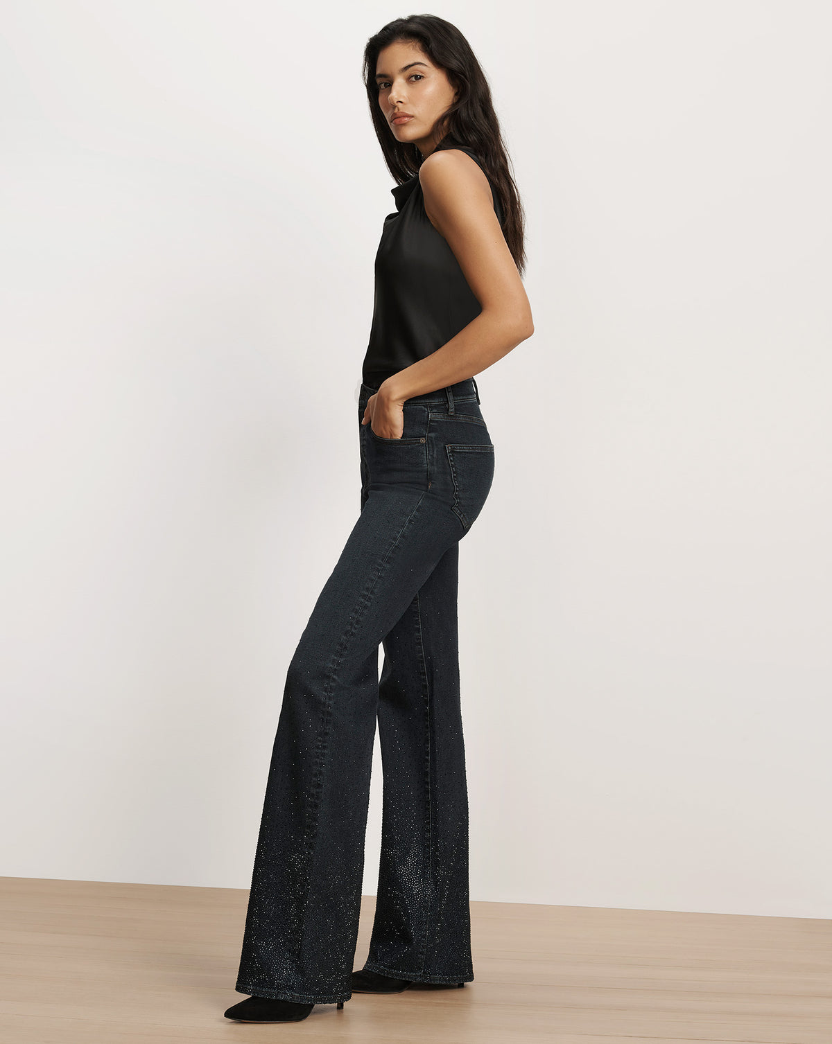 Veronica Beard Black sleeveless top and embellished flare jeans.