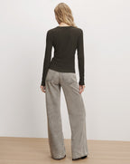 Veronica Beard Dark green long-sleeve top and grey jeans.