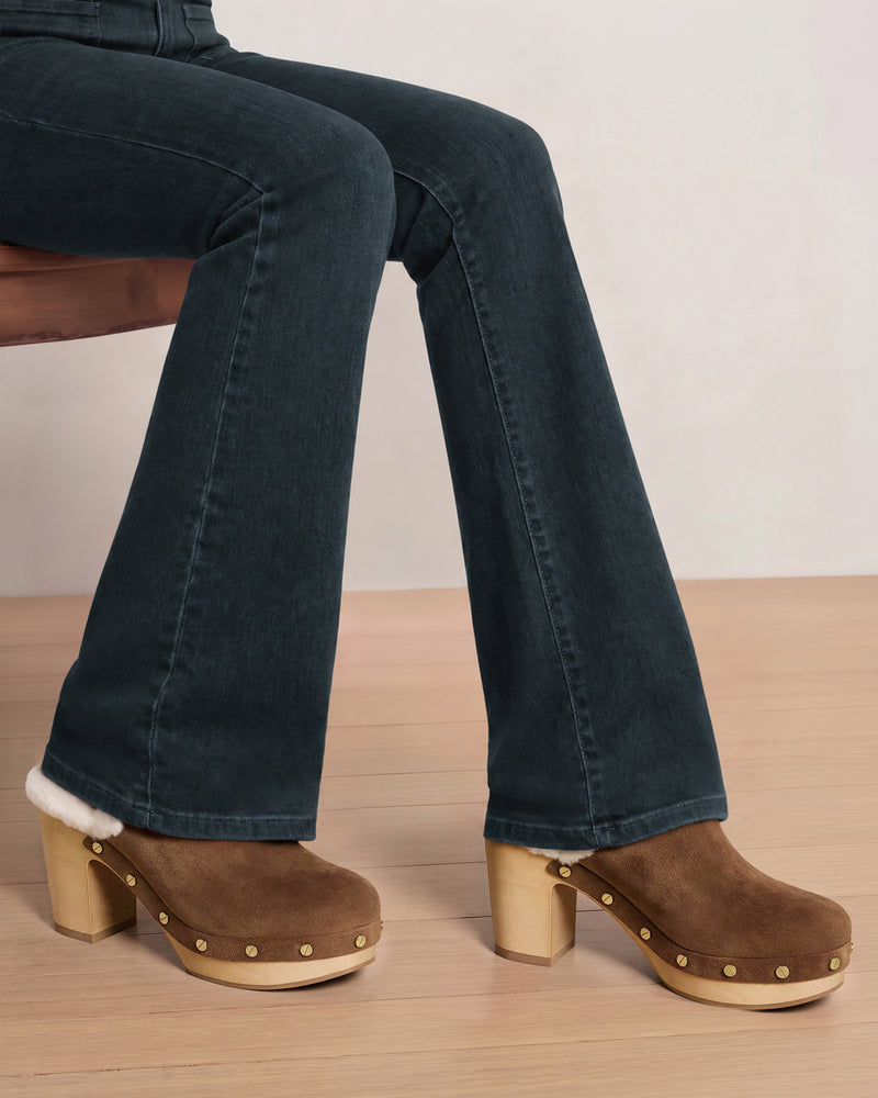 Veronica Beard Dark blue flare denim jeans and brown clogs.