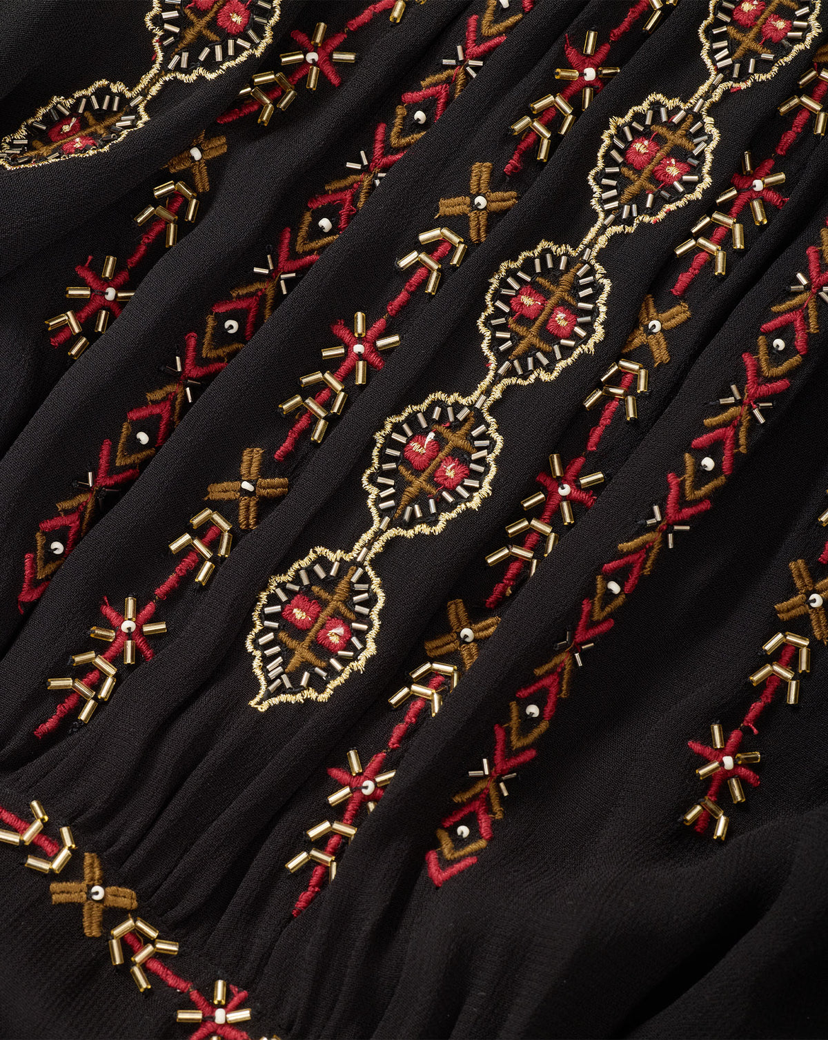 Veronica Beard Black embroidered dress with red and gold details.