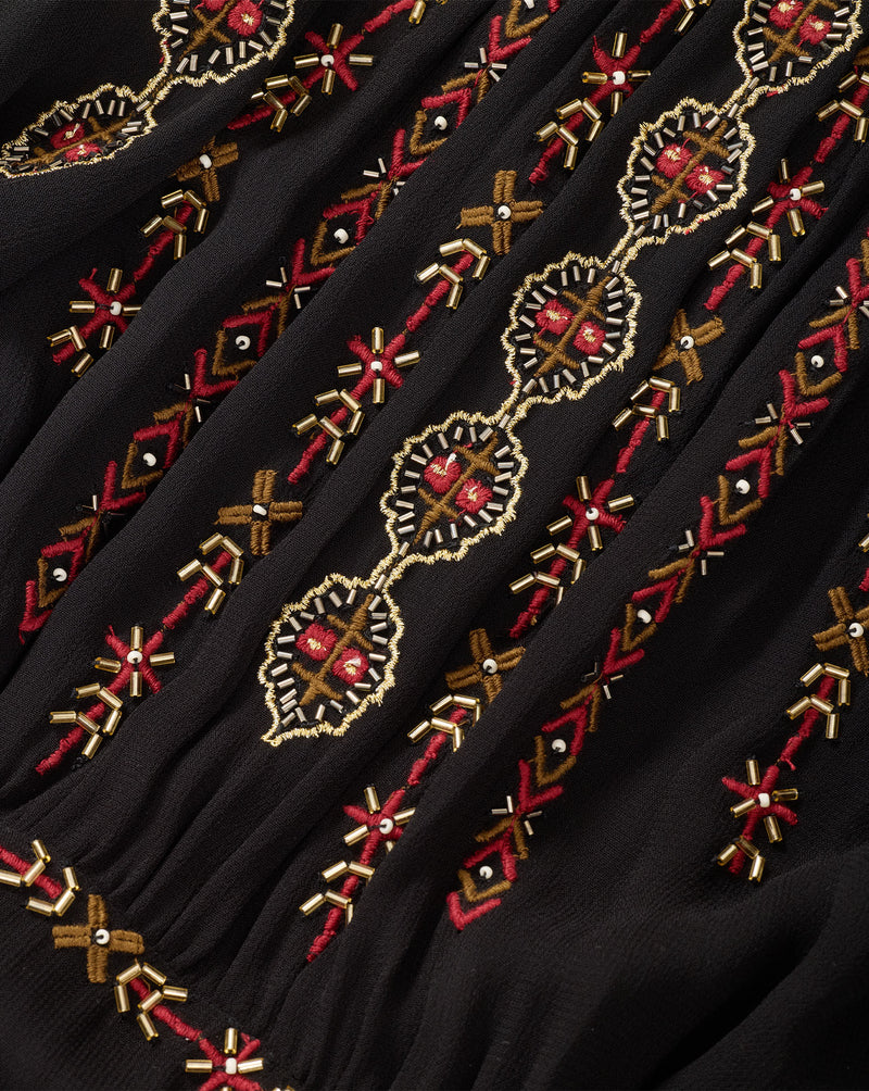 Veronica Beard Black embroidered dress with red and gold details.