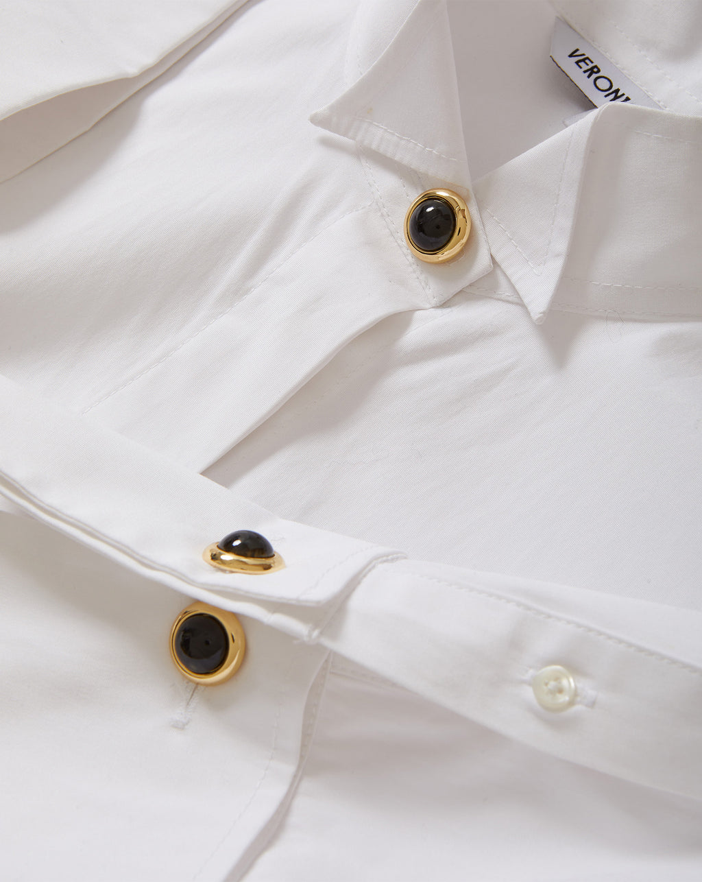 Veronica Beard White shirt with gold and black buttons.