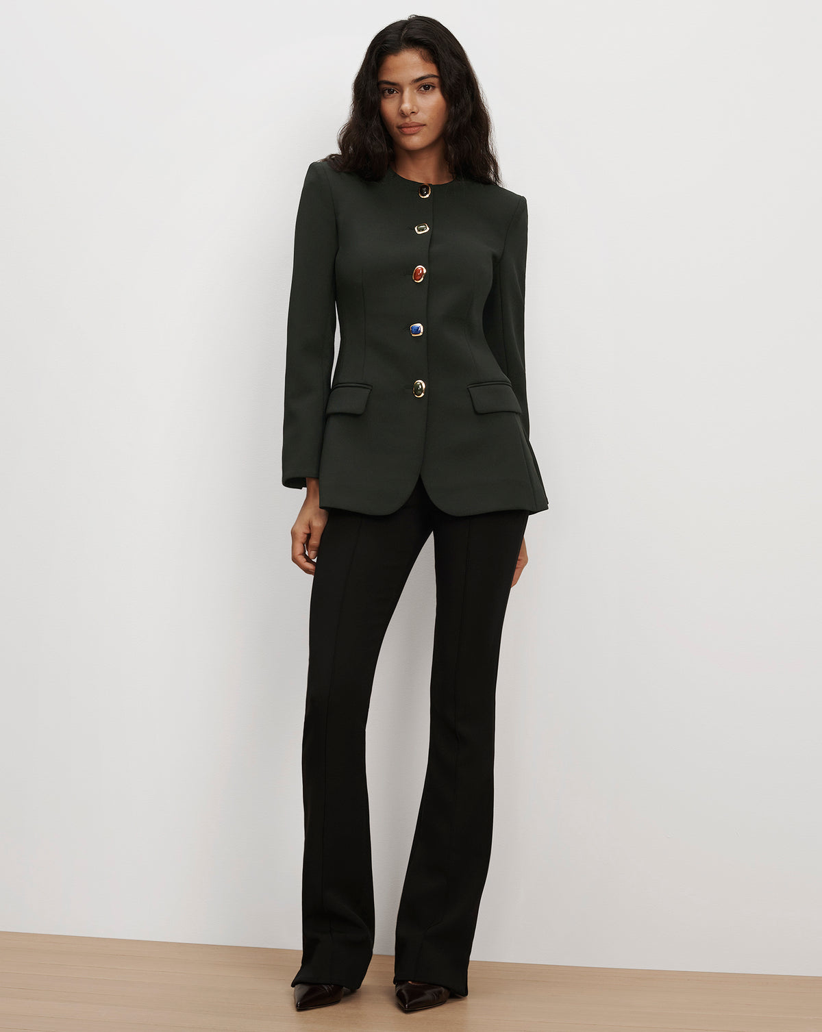 Veronica Beard Dark green tailored jacket with gemstone buttons.