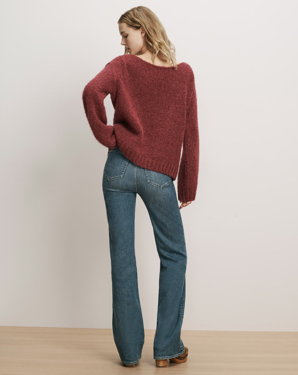 Veronica Beard Red fuzzy knit sweater and blue denim jeans.