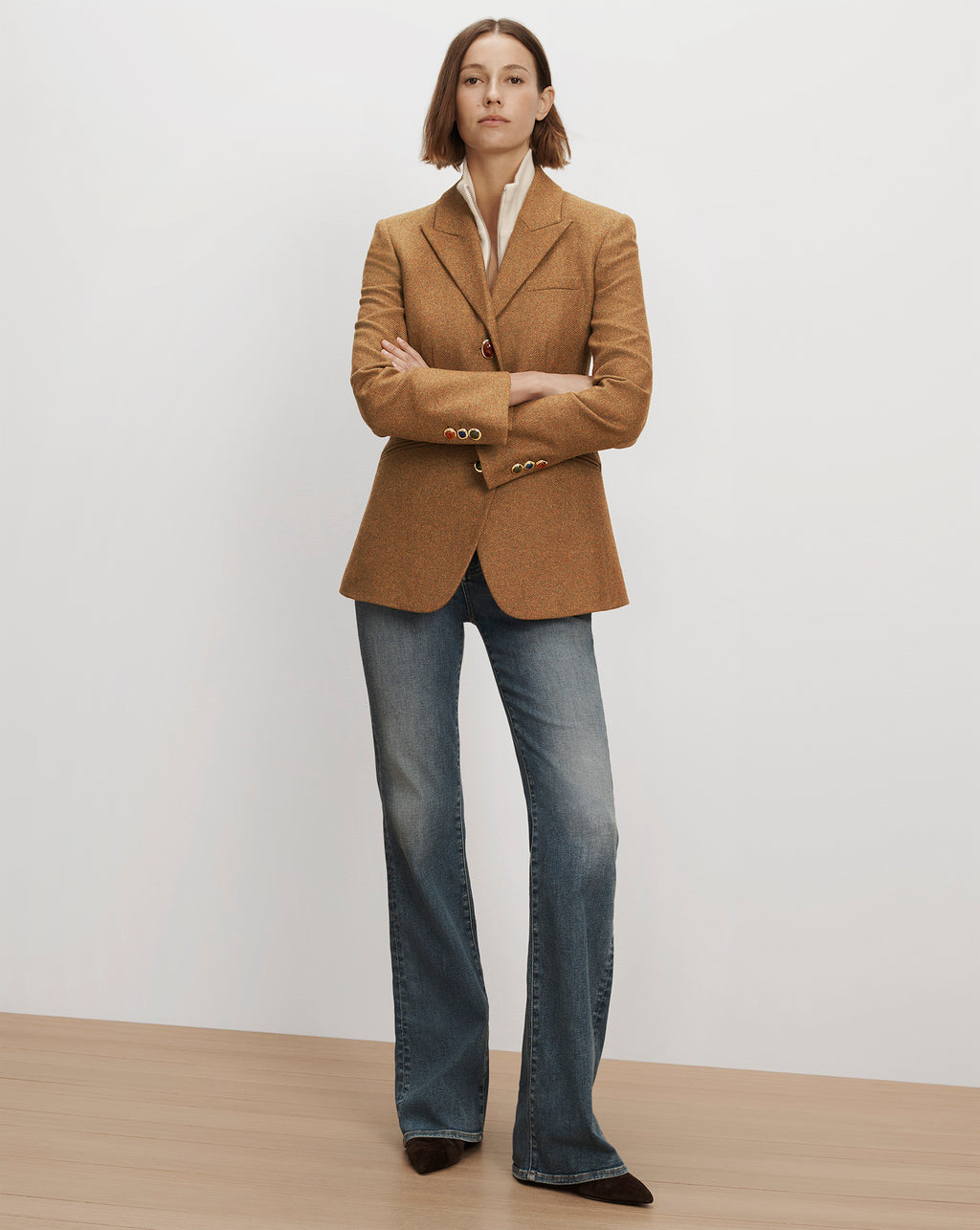 Veronica Beard Brown tweed blazer with colorful buttons and blue jeans.
