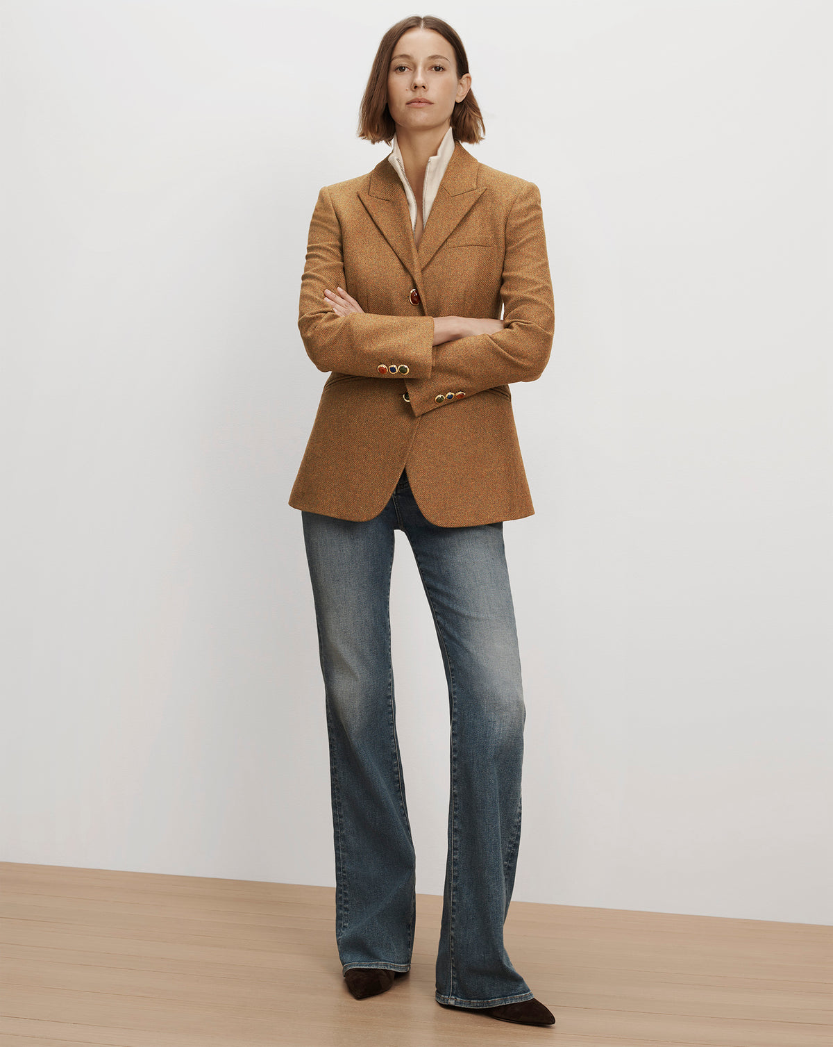 Veronica Beard Brown tweed blazer with colorful buttons and blue jeans.