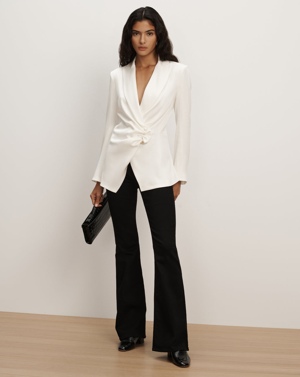 Veronica Beard White blazer, black flared trousers outfit.