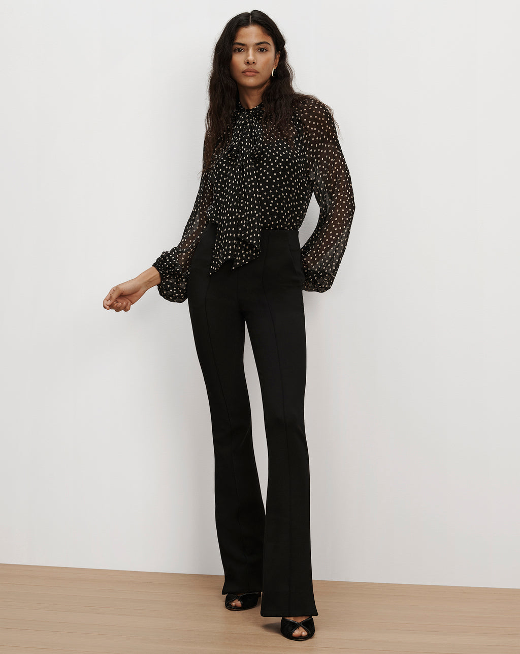 Veronica Beard Black polka dot blouse and black flared pants.