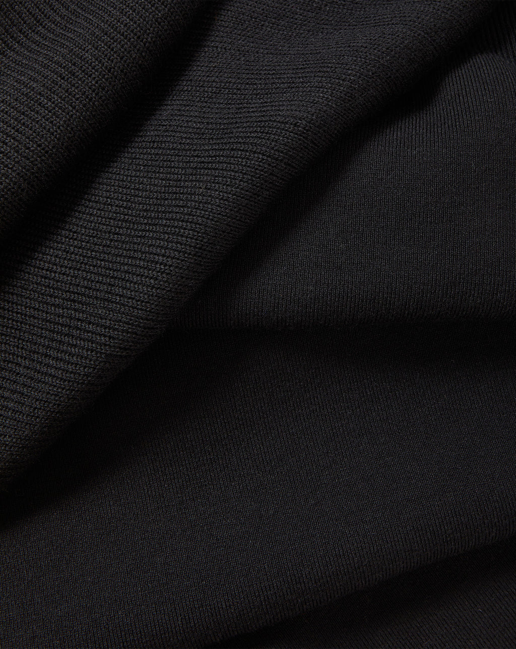 Veronica Beard Black knit fabric with ribbed texture detail.