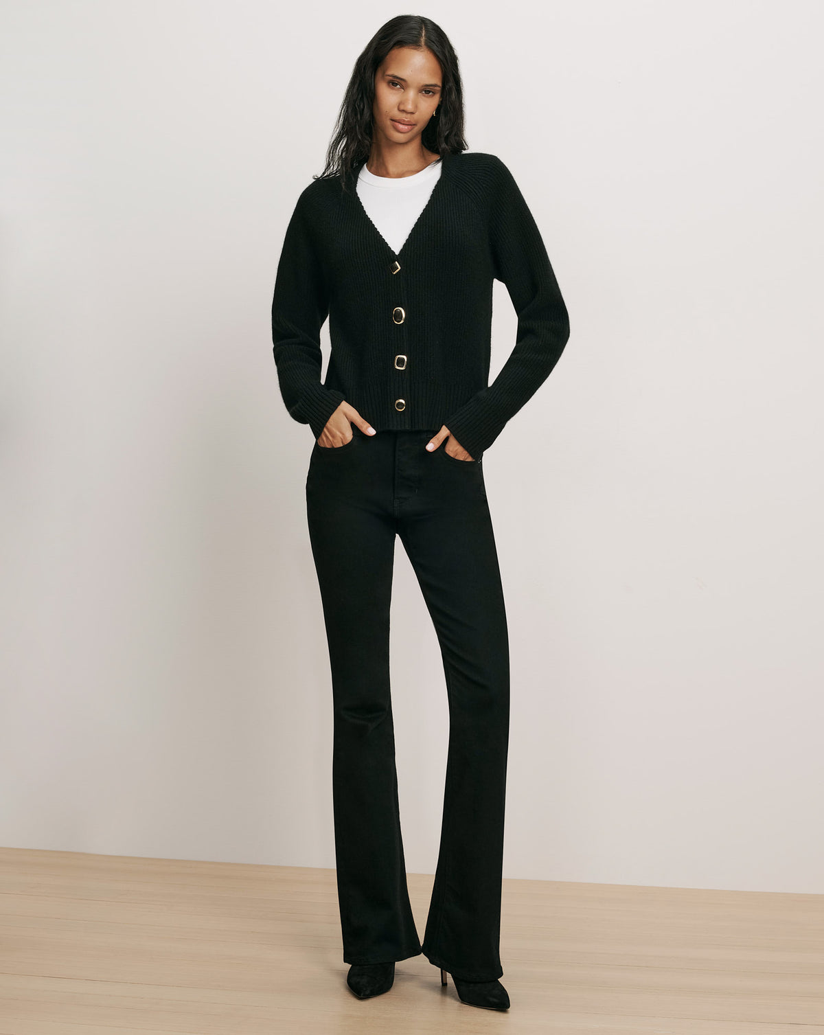 Veronica Beard Black knit cardigan with gold buttons and trousers.