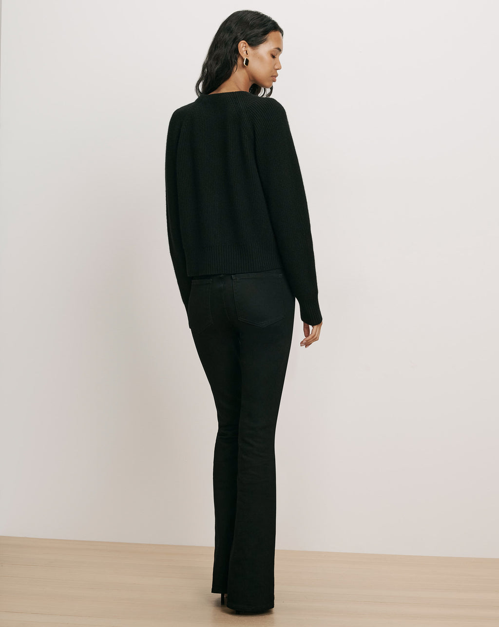 Veronica Beard Black ribbed knit sweater and jeans.
