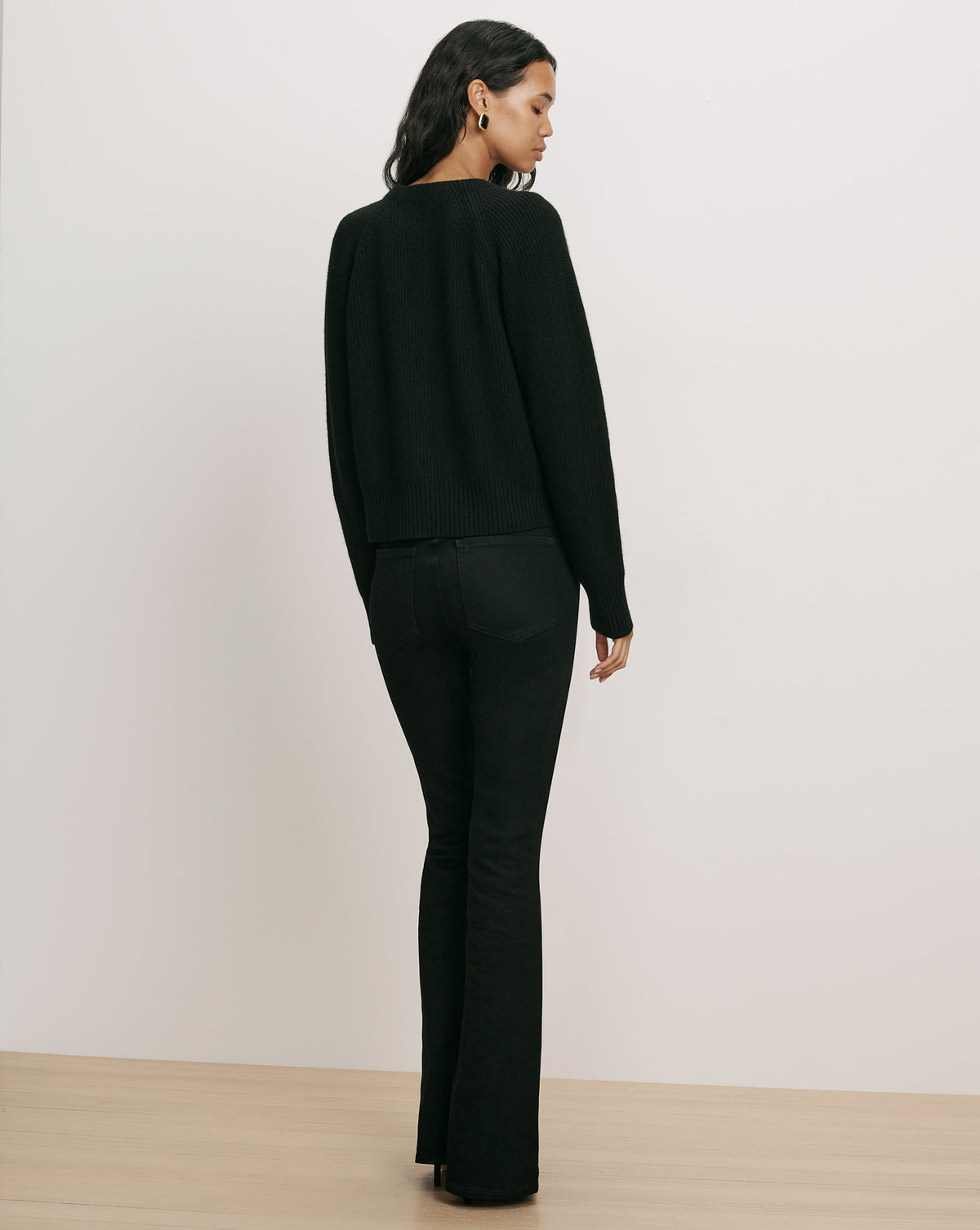 Veronica Beard Black ribbed knit sweater and jeans.