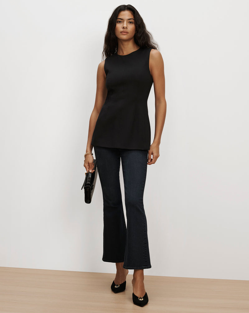 Veronica Beard Black sleeveless top and dark denim flare jeans.
