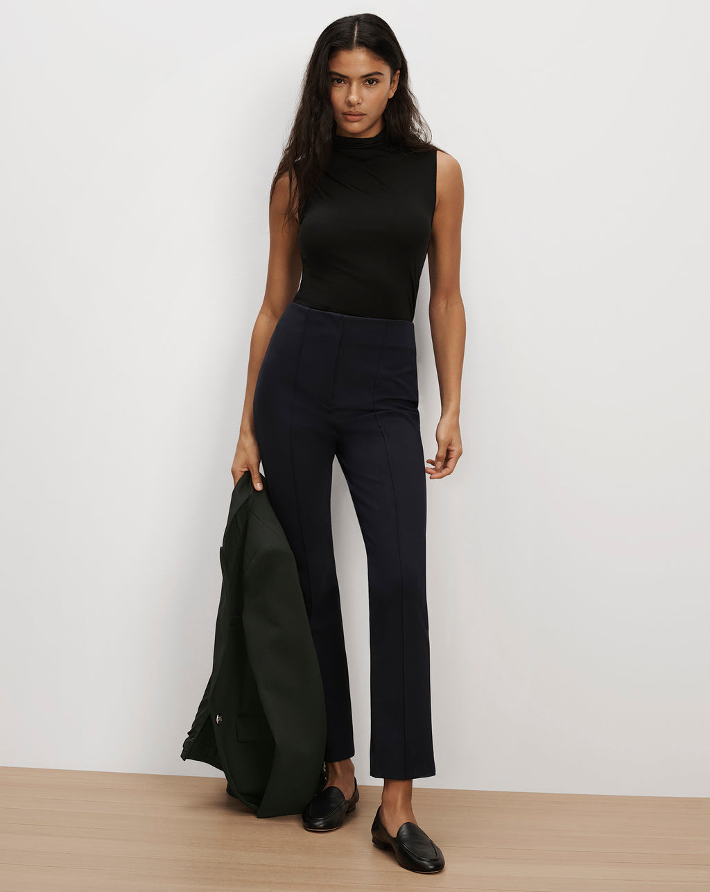 Veronica Beard Black sleeveless top and navy blue trousers.