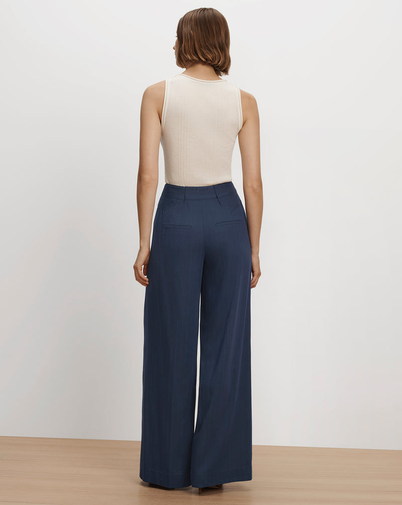 Veronica Beard Blue wide-leg trousers and beige ribbed tank top.