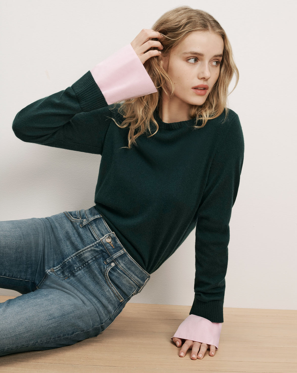 Veronica Beard Dark green knit sweater with pink cuffs.