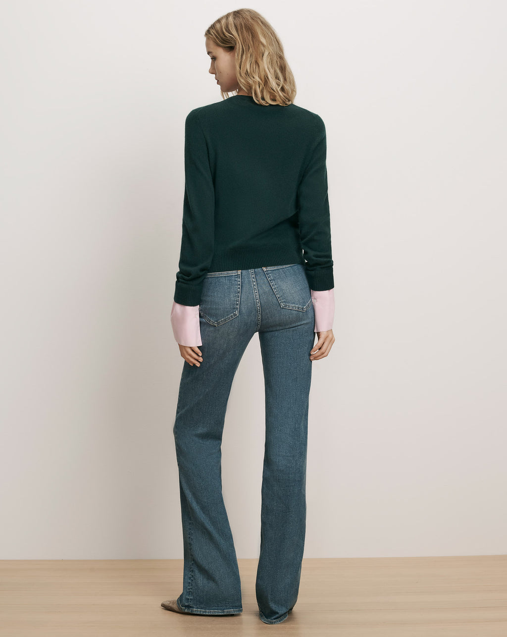 Veronica Beard Dark green crewneck sweater and blue jeans.