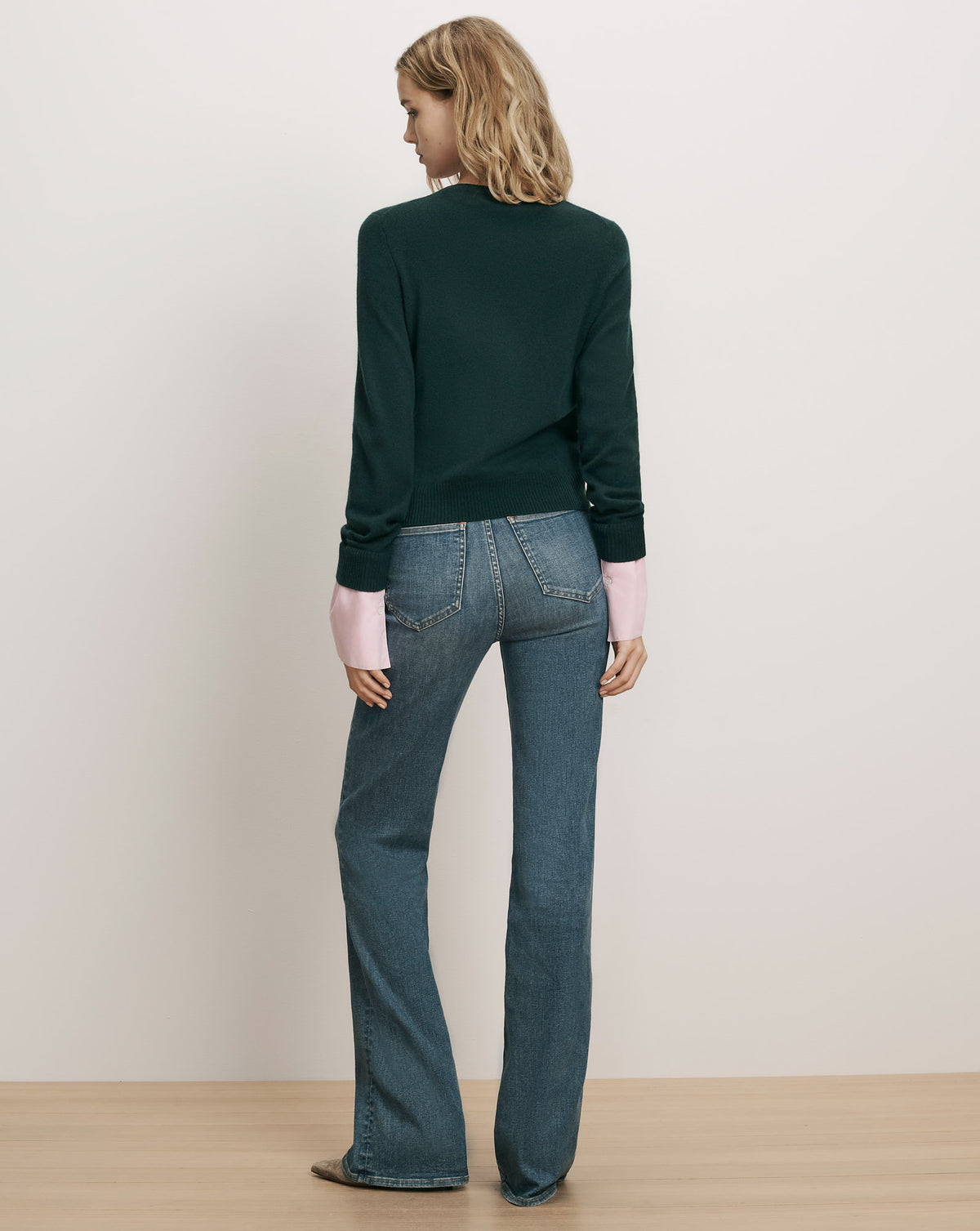 Veronica Beard Dark green crewneck sweater and blue jeans.