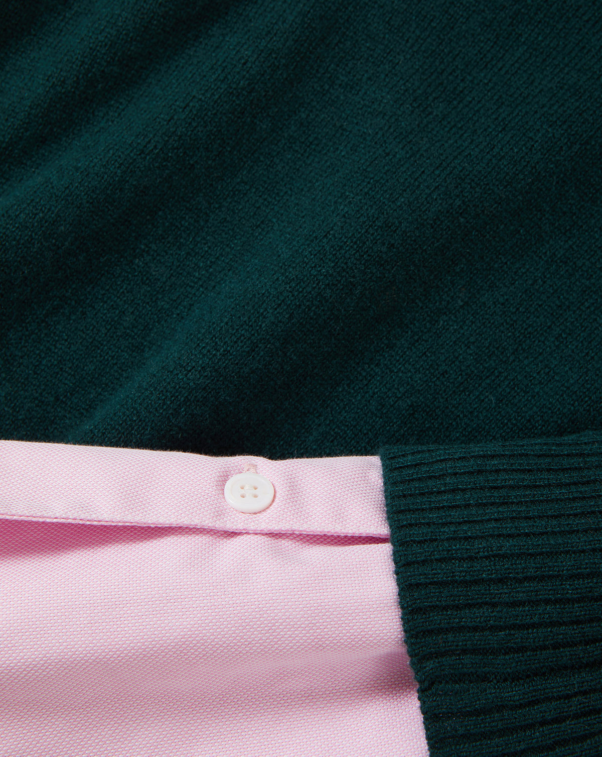 Veronica Beard Dark green knit sweater with pink shirt.