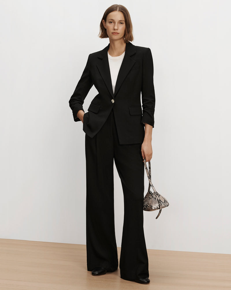 Veronica Beard Black tailored suit with wide trousers.