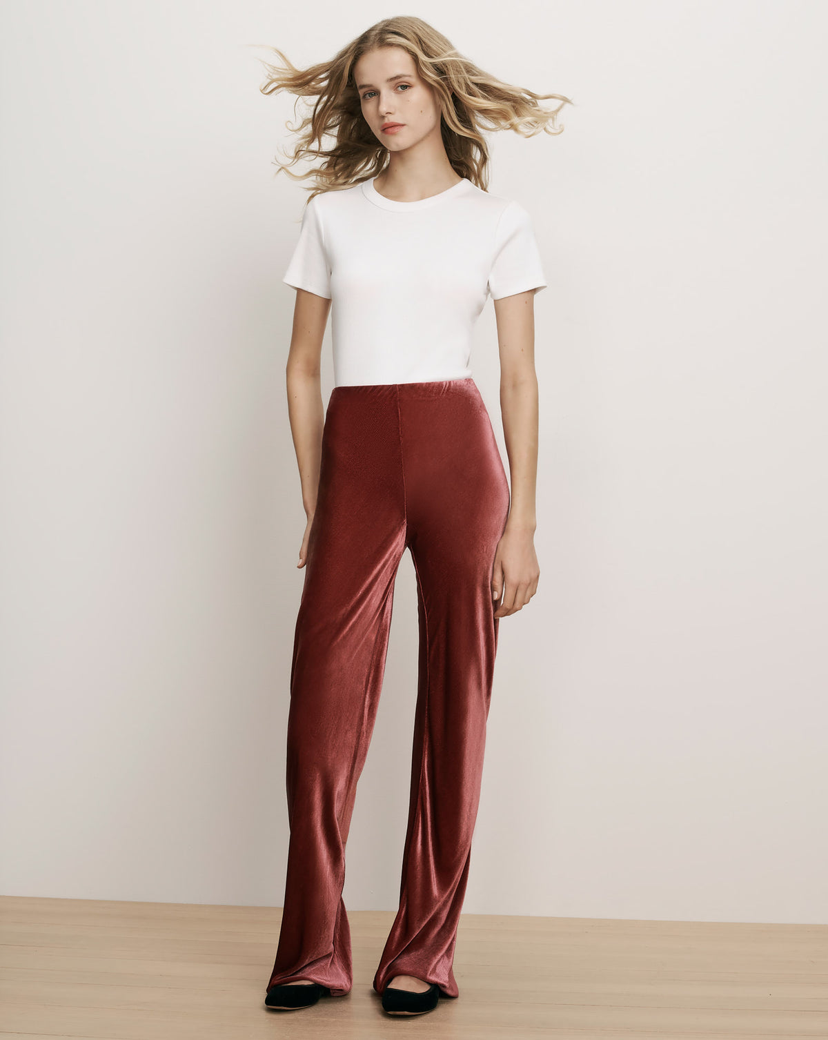 Veronica Beard White t-shirt and wide-leg red velvet pants.