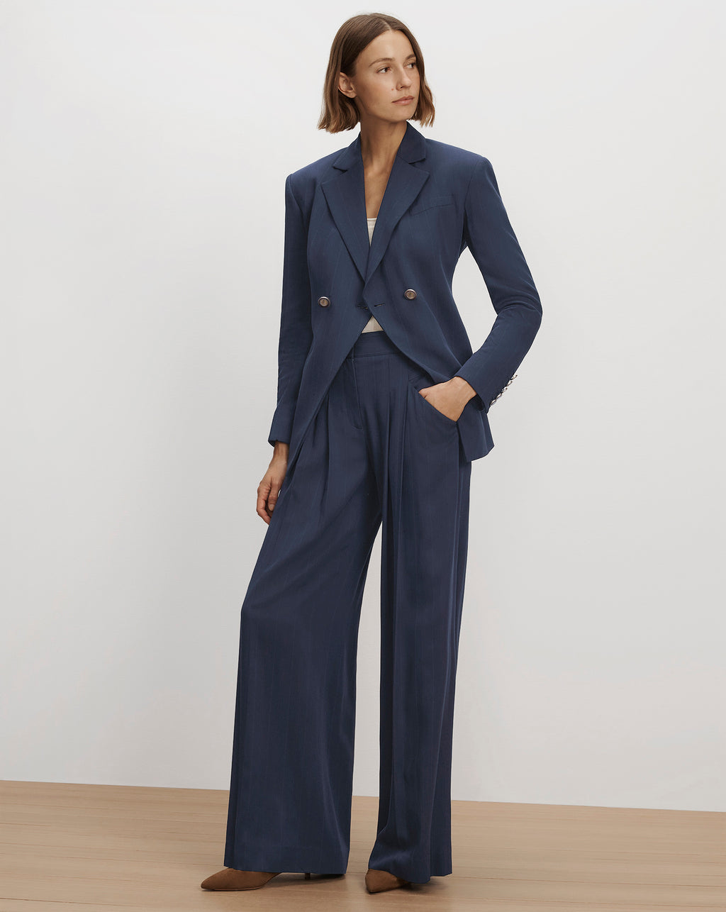 Veronica Beard Navy blue double-breasted suit with wide trousers.