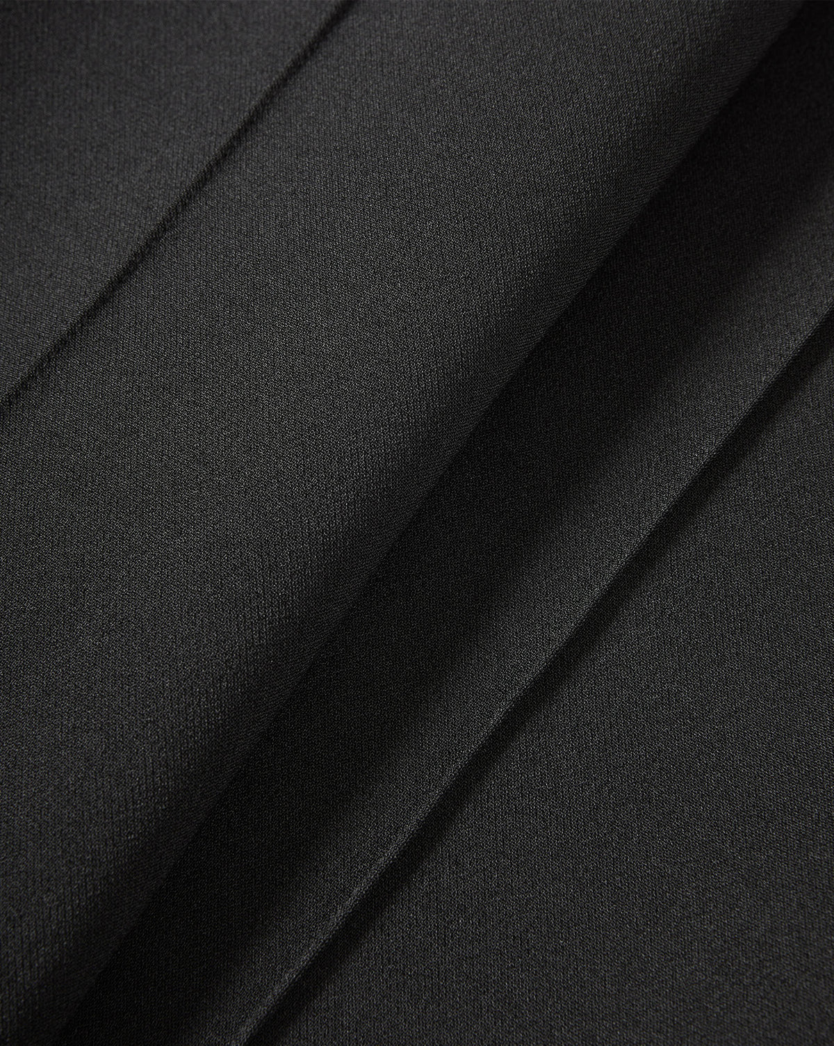 Veronica Beard Black pleated trousers fabric close-up.
