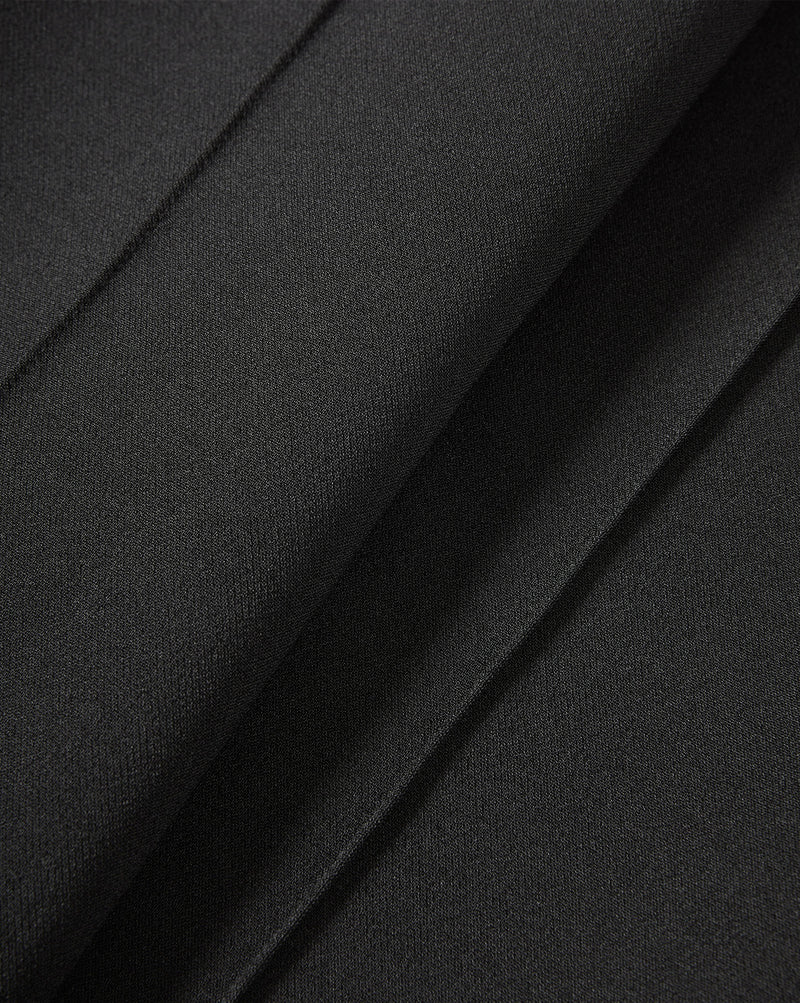 Veronica Beard Black pleated trousers fabric close-up.
