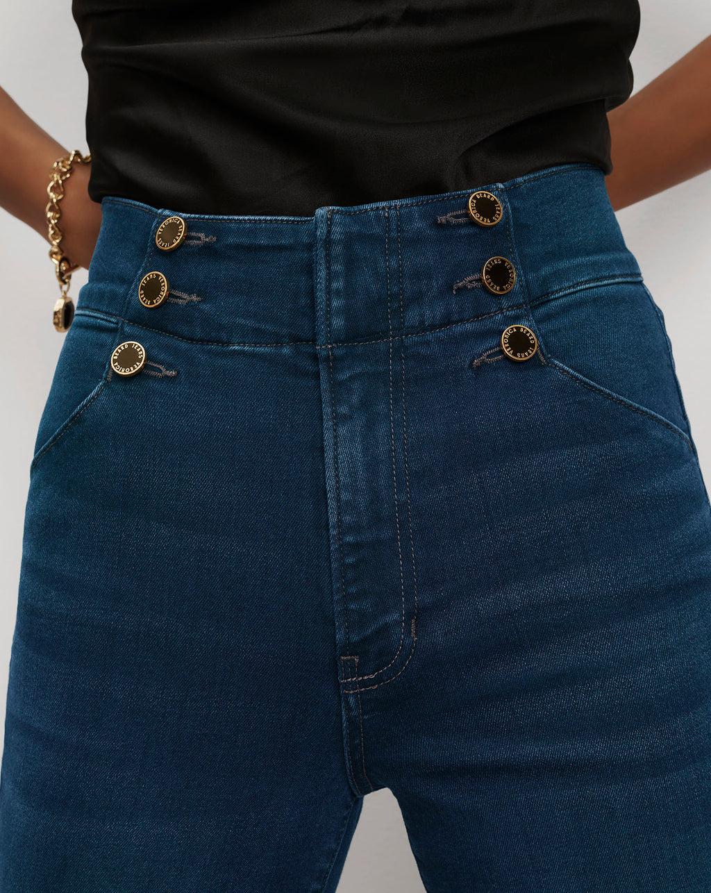 Veronica Beard Blue high-waisted denim pants with gold button details.