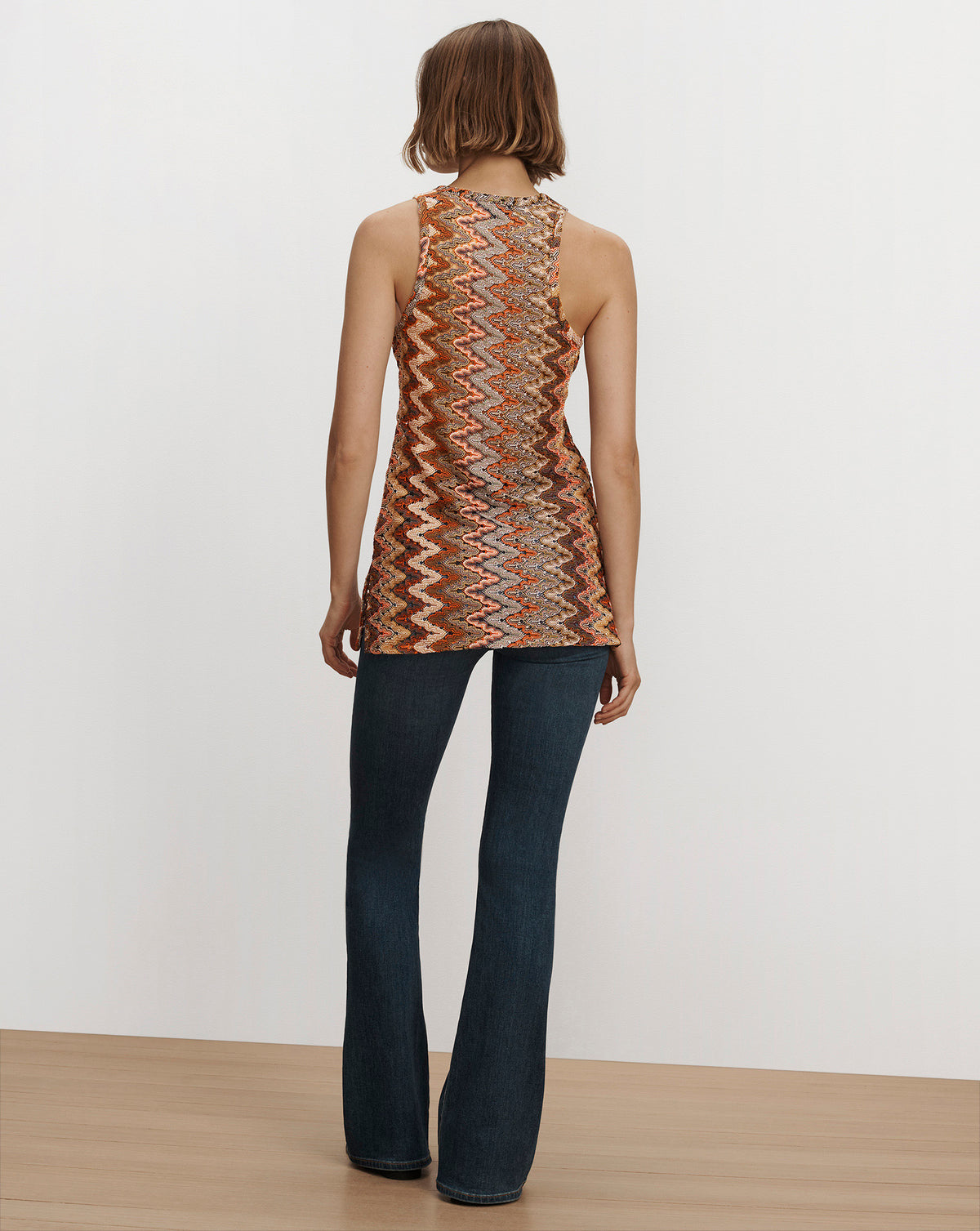 Veronica Beard Multicolor zig-zag sleeveless top and blue jeans.