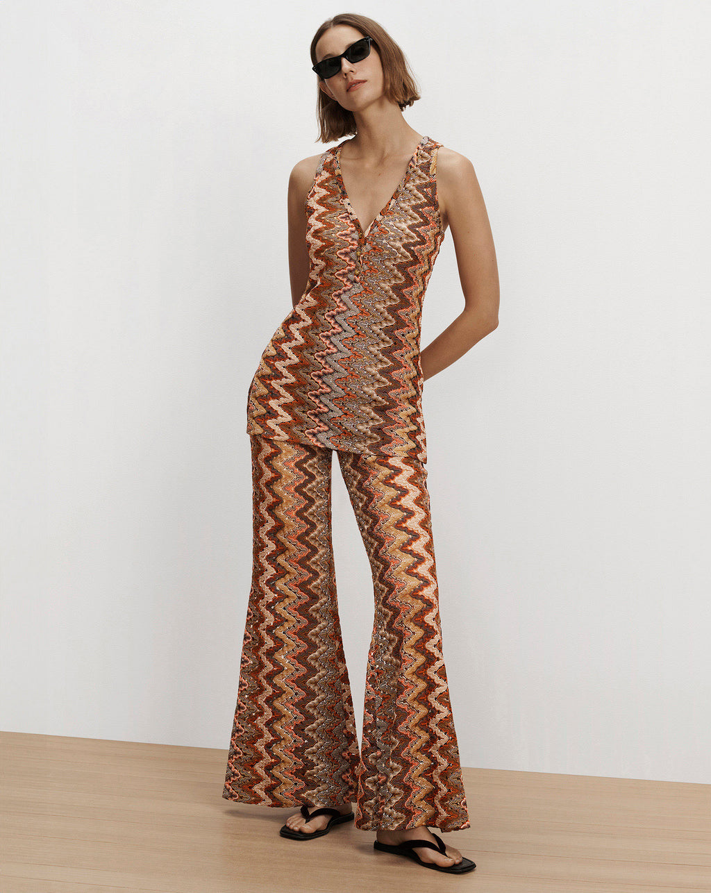 Veronica Beard Orange chevron-patterned sequin sleeveless top and flared pants.