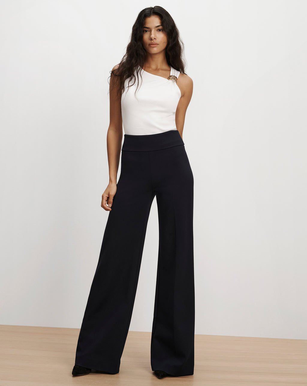 Veronica Beard Black wide-leg trousers and white top.